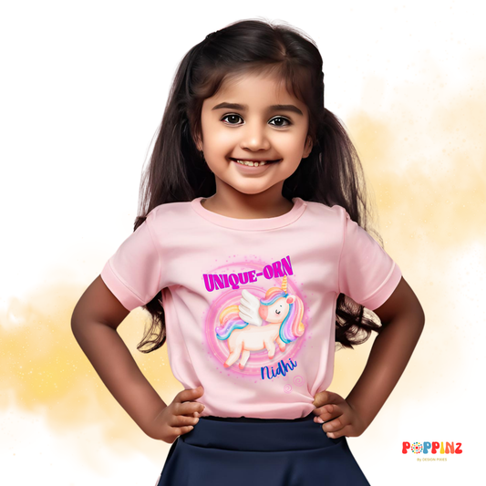 Girl wearing pink cotton unicorn themed t-shirt, personalized with name - Design Pixies